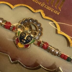 A thread featuring a Krishna-like face on a colorful rakhi