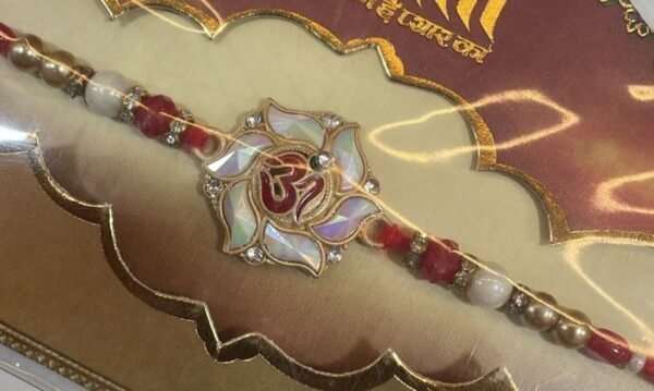 A beautifully crafted Rakhi with an Om symbol.