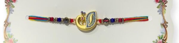 An Indian peacock Rakhi with colorful beads.