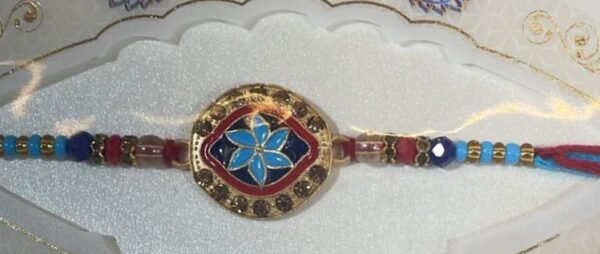 Blue flower Rakhi with maroon and gold accents bracelet