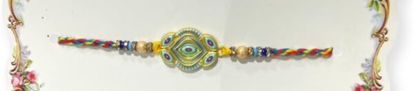 A vibrant Rakhi with a golden, evil-eye-inspired  braided, multicolored thread.